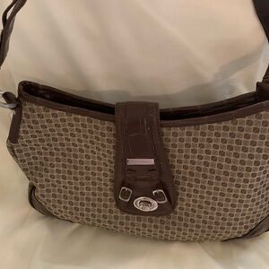 Nine and co handbag by Nine West with zipper and buckle for closure.
